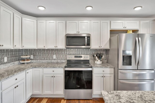 4717 Lunns Store Rd, Chapel Hill, TN 37034 - kitchen with appliances with stainless steel finishes, white cabinetry, and light stone counters