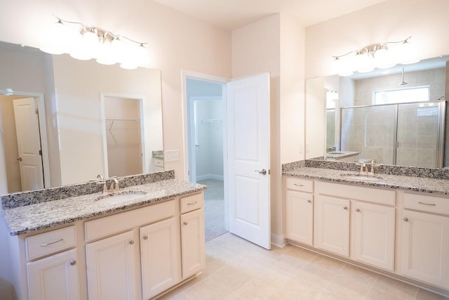 213 Rosemary Way, Mount Juliet, TN 37122 - bathroom featuring a stall shower, two vanities, and a spacious closet