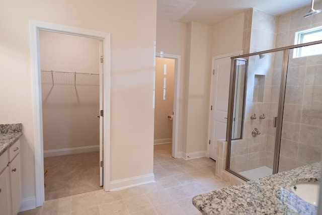 213 Rosemary Way, Mount Juliet, TN 37122 - bathroom with vanity, a stall shower, a spacious closet, and baseboards