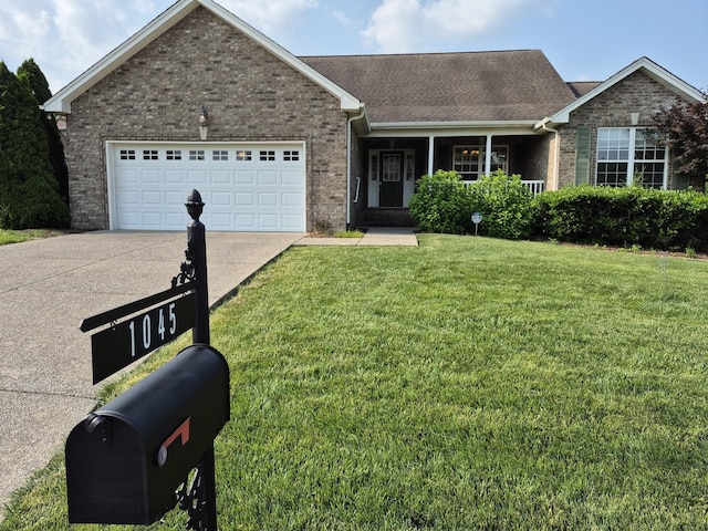 1045 Oakhall Dr, Mount Juliet, TN 37122 - ranch-style house with brick siding, concrete driveway, a front yard, and an attached garage