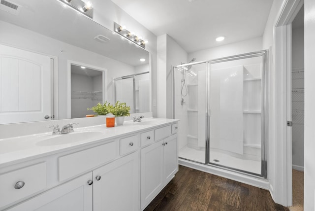 148 Victory Cir, Ashland City, TN 37015 - bathroom featuring a spacious closet, a shower stall, double vanity, wood finished floors, and recessed lighting
