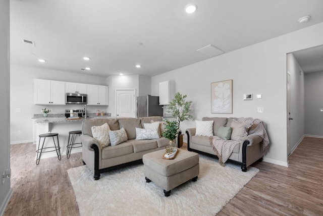 148 Victory Cir, Ashland City, TN 37015 - living room with light wood finished floors, baseboards, and recessed lighting