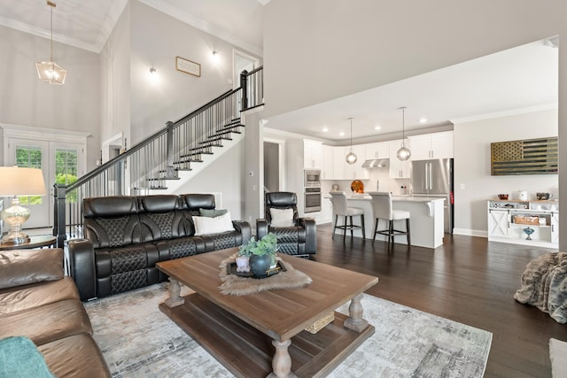 290 Academy Rd, Lebanon, TN 37087 - living area featuring dark wood-style floors, a towering ceiling, crown molding, stairs, and recessed lighting