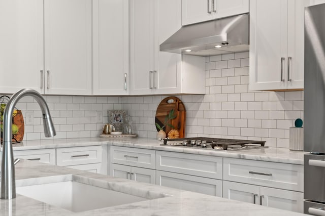 290 Academy Rd, Lebanon, TN 37087 - kitchen with under cabinet range hood, stainless steel gas cooktop, white cabinetry, and a sink