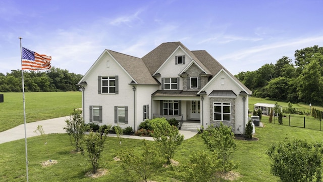 290 Academy Rd, Lebanon, TN 37087 - view of front of house with covered porch, a shingled roof, stone siding, and central AC unit