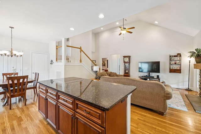 2090 Lequire Ln, Spring Hill, TN 37174 - kitchen featuring light wood-style flooring, a ceiling fan, a center island, a chandelier, and high vaulted ceiling