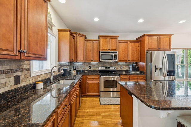 2090 Lequire Ln, Spring Hill, TN 37174 - kitchen featuring stainless steel appliances, a sink, light wood-type flooring, brown cabinetry, and recessed lighting