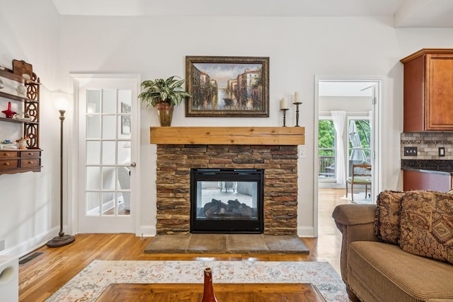2090 Lequire Ln, Spring Hill, TN 37174 - living room with wood finished floors, baseboards, and a stone fireplace