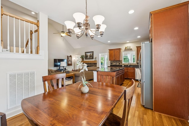 2090 Lequire Ln, Spring Hill, TN 37174 - dining space featuring a chandelier, recessed lighting, ceiling fan, light wood-type flooring, and a fireplace