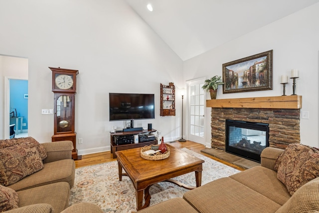 2090 Lequire Ln, Spring Hill, TN 37174 - living area featuring high vaulted ceiling, baseboards, light wood-style flooring, and a stone fireplace