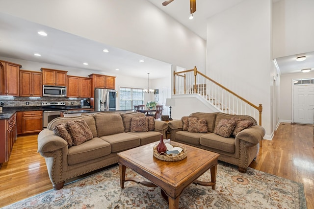 2090 Lequire Ln, Spring Hill, TN 37174 - living area featuring light wood-style floors, a ceiling fan, recessed lighting, stairs, and a high ceiling