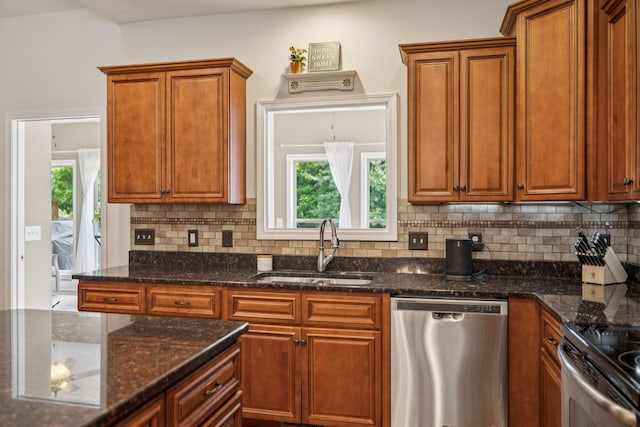 2090 Lequire Ln, Spring Hill, TN 37174 - kitchen with appliances with stainless steel finishes, a sink, decorative backsplash, and brown cabinetry
