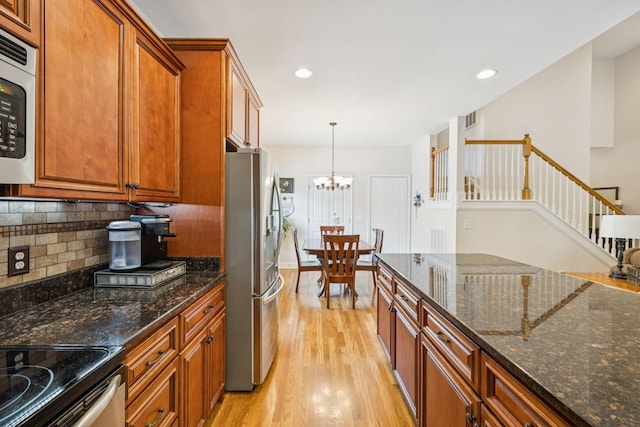 2090 Lequire Ln, Spring Hill, TN 37174 - kitchen with stainless steel appliances, brown cabinets, light wood-type flooring, tasteful backsplash, and recessed lighting