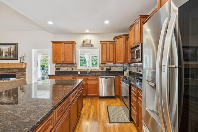 2090 Lequire Ln, Spring Hill, TN 37174 - kitchen featuring stainless steel appliances, a sink, light wood-style flooring, brown cabinetry, and recessed lighting