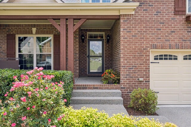 2090 Lequire Ln, Spring Hill, TN 37174 - view of exterior entry with brick siding and a garage