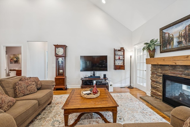 2090 Lequire Ln, Spring Hill, TN 37174 - living area featuring high vaulted ceiling, a stone fireplace, wood finished floors, and baseboards