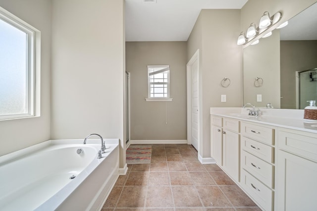 1426 Alamo Ave, Murfreesboro, TN 37129 - full bath featuring vanity, a garden tub, a shower with shower door, and baseboards