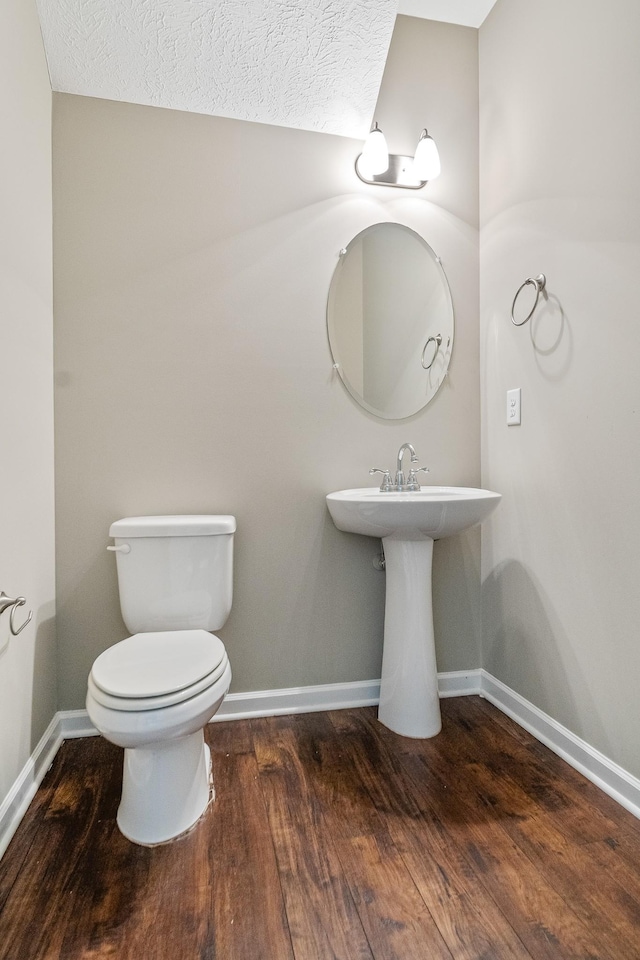 1426 Alamo Ave, Murfreesboro, TN 37129 - bathroom featuring wood finished floors, toilet, baseboards, and a textured ceiling