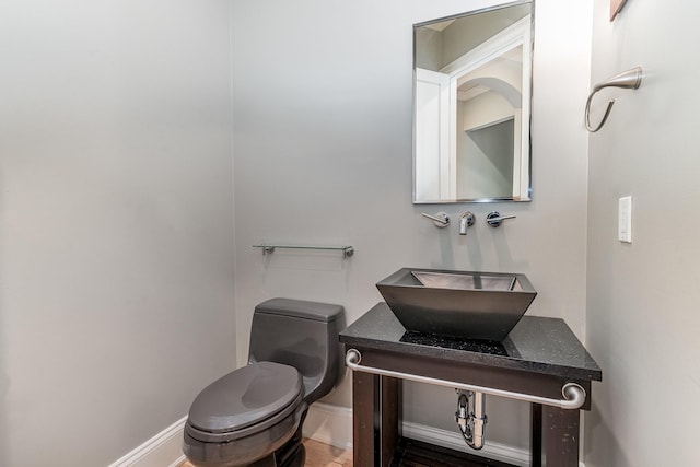 1107 Stonebridge Park Dr, Franklin, TN 37069 - half bathroom featuring toilet, baseboards, a sink, and wood finished floors