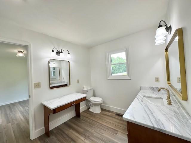 807 Poplar Dr, Centerville, TN 37033 - bathroom featuring vanity, wood finished floors, baseboards, and toilet
