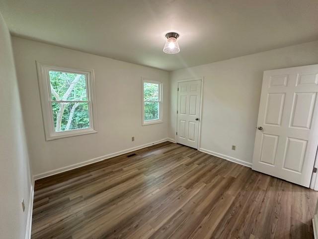 807 Poplar Dr, Centerville, TN 37033 - unfurnished bedroom featuring dark wood finished floors and baseboards