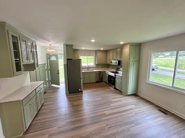807 Poplar Dr, Centerville, TN 37033 - kitchen featuring appliances with stainless steel finishes, a sink, green cabinetry, light wood finished floors, and recessed lighting
