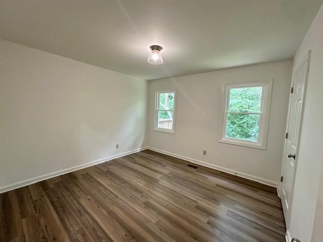 807 Poplar Dr, Centerville, TN 37033 - spare room with dark wood-style floors and baseboards