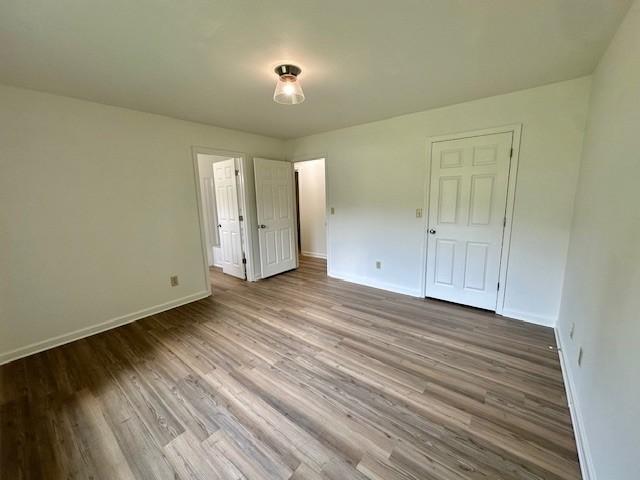 807 Poplar Dr, Centerville, TN 37033 - unfurnished bedroom featuring baseboards and wood finished floors