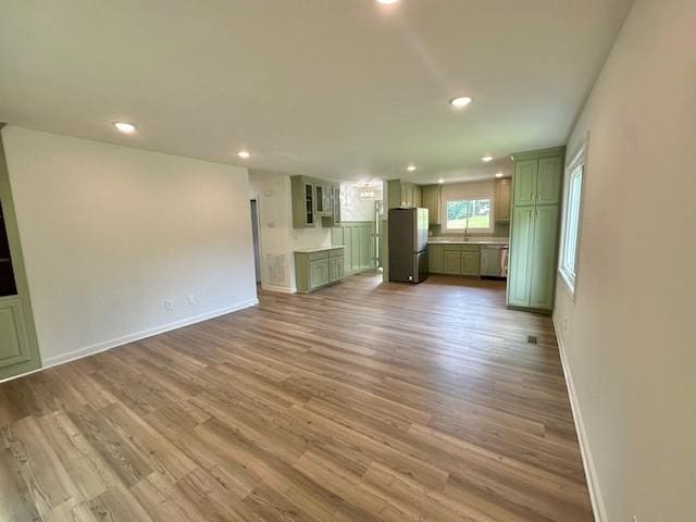 807 Poplar Dr, Centerville, TN 37033 - unfurnished living room with recessed lighting, wood finished floors, baseboards, and a sink