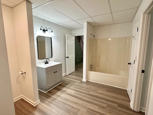 807 Poplar Dr, Centerville, TN 37033 - full bath with a paneled ceiling, vanity, shower / washtub combination, baseboards, and wood finished floors