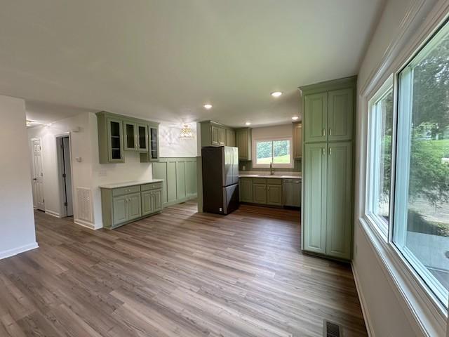 807 Poplar Dr, Centerville, TN 37033 - kitchen featuring stainless steel appliances, green cabinets, wood finished floors, baseboards, and recessed lighting