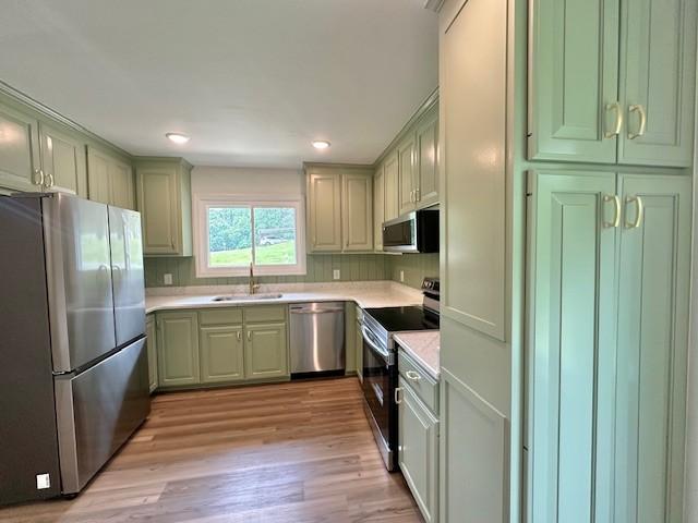 807 Poplar Dr, Centerville, TN 37033 - kitchen featuring stainless steel appliances, a sink, light countertops, green cabinets, and recessed lighting
