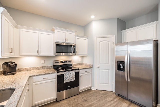 1110 Colonel Reuben Searcy Ct, Murfreesboro, TN 37129 - kitchen featuring appliances with stainless steel finishes, white cabinetry, recessed lighting, light wood finished floors, and light stone countertops