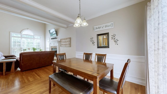 4015 Sleepyhollow Way, Mount Juliet, TN 37122 - dining area featuring crown molding, light wood-style floors, a fireplace, and wainscoting