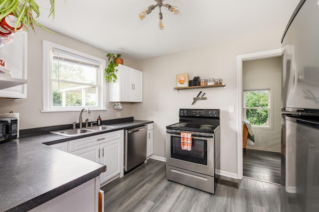 102 Lyle Ln, Nashville, TN 37210 - kitchen with stainless steel appliances, dark countertops, a sink, and healthy amount of natural light
