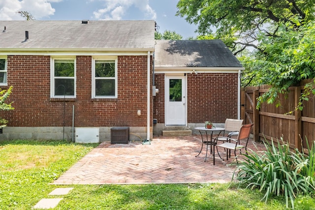 102 Lyle Ln, Nashville, TN 37210 - rear view of house featuring brick siding, a shingled roof, and a patio