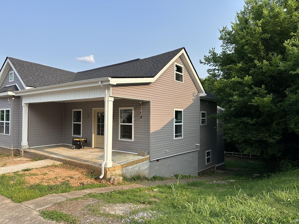 120 Union St, Clarksville, TN 37040 - view of side of home with a shingled roof and a patio