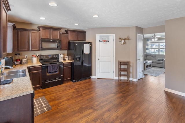 2541 Jackalope St, Murfreesboro, TN 37130 - kitchen featuring black appliances, a sink, light countertops, dark wood finished floors, and recessed lighting