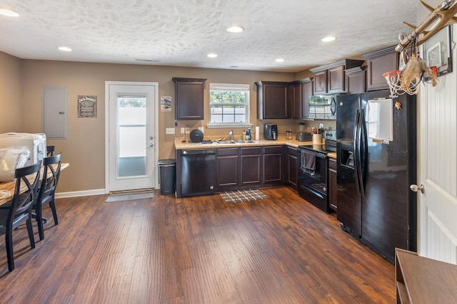 2541 Jackalope St, Murfreesboro, TN 37130 - kitchen with black appliances, light countertops, dark brown cabinets, a sink, and dark wood-style flooring