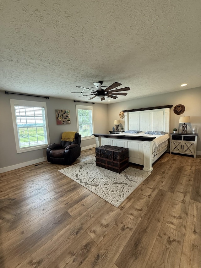 285 Shrum Ln, Lafayette, TN 37083 - bedroom with hardwood / wood-style flooring, baseboards, multiple windows, and a textured ceiling