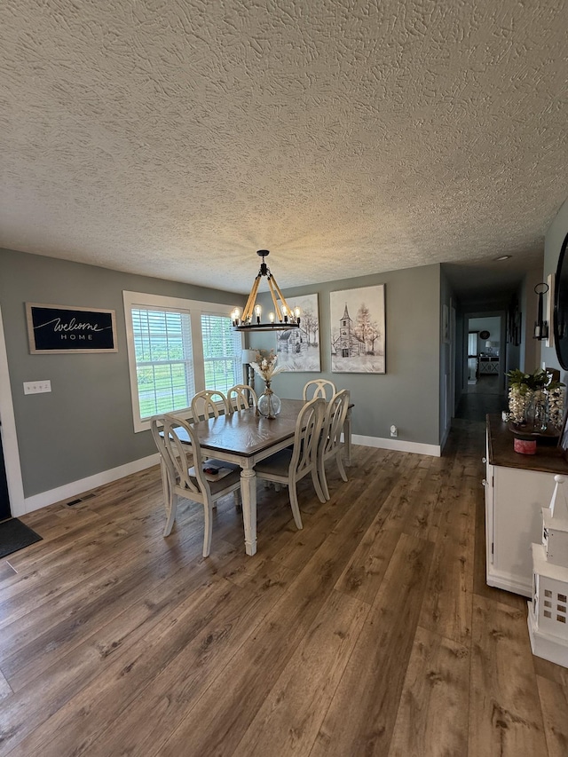 285 Shrum Ln, Lafayette, TN 37083 - dining room with a textured ceiling, a chandelier, wood finished floors, and baseboards