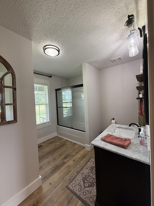 285 Shrum Ln, Lafayette, TN 37083 - full bathroom featuring a shower with door, wood finished floors, vanity, baseboards, and a textured ceiling