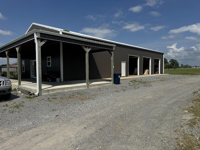 285 Shrum Ln, Lafayette, TN 37083 - view of property exterior with a garage and an outbuilding