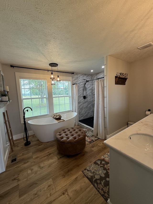 285 Shrum Ln, Lafayette, TN 37083 - full bath featuring a textured ceiling, vanity, wood finished floors, a tile shower, and a freestanding bath