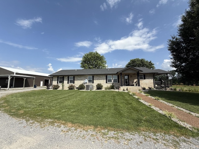 285 Shrum Ln, Lafayette, TN 37083 - ranch-style home featuring a front yard, central AC unit, and brick siding