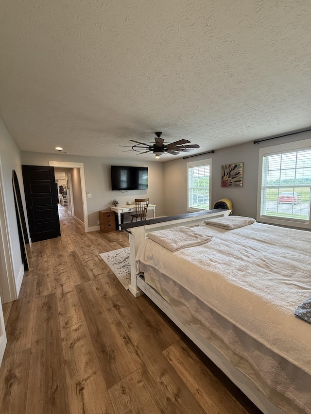 285 Shrum Ln, Lafayette, TN 37083 - bedroom featuring a textured ceiling, hardwood / wood-style flooring, baseboards, and ceiling fan
