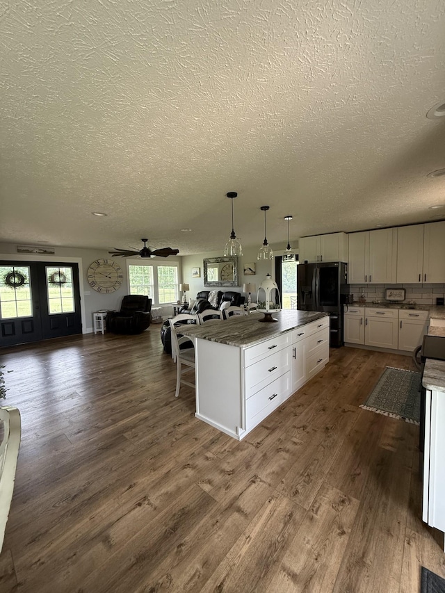 285 Shrum Ln, Lafayette, TN 37083 - kitchen featuring fridge with ice dispenser, a textured ceiling, open floor plan, white cabinets, and dark wood-type flooring