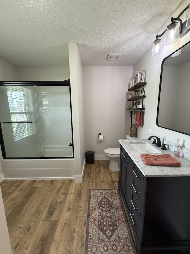 285 Shrum Ln, Lafayette, TN 37083 - full bath with vanity, wood finished floors, enclosed tub / shower combo, toilet, and baseboards