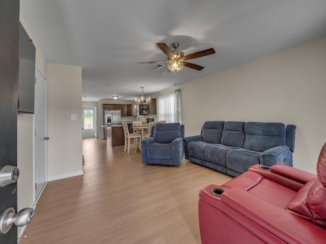201 Quarry Overlook Way, Clarksville, TN 37043 - living room with light wood-style flooring, ceiling fan, healthy amount of natural light, and a chandelier