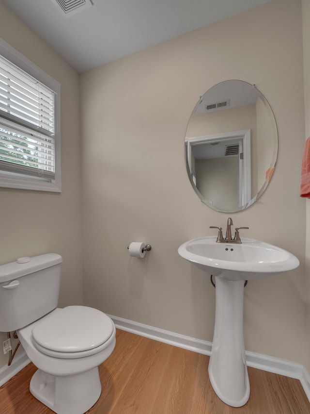 201 Quarry Overlook Way, Clarksville, TN 37043 - bathroom featuring wood finished floors, toilet, baseboards, and a sink
